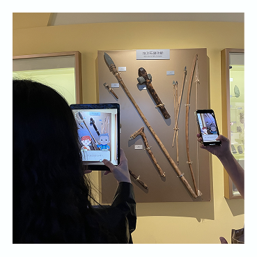 A visitor using an interactive museum kiosk