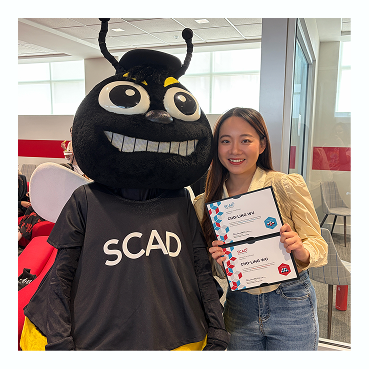 Jolyne with the SCAD mascot at graduation